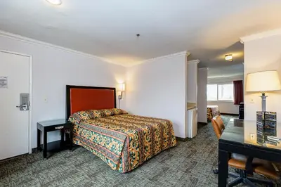 a hotel room with a bed and a desk at Buena Vista Inn in Anaheim