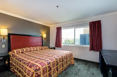 a hotel room with a bed and a window at Buena Vista Inn in Anaheim