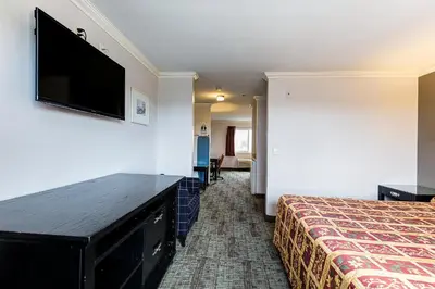 a hotel room with a bed and a flat screen tv at Buena Vista Inn in Anaheim