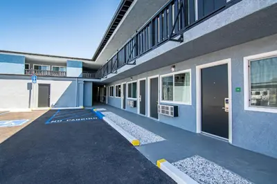 an empty building with a parking lot in front of it at Motel 6 Ridgecrest, CA China Lake in Ridgecrest