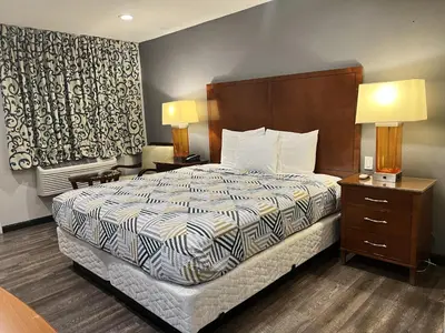 a hotel room with a bed and two night stands at Motel 6 Ridgecrest, CA China Lake in Ridgecrest