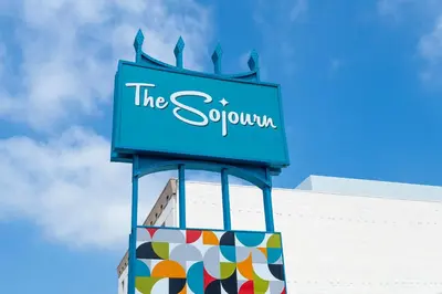 a sign on top of a shopping center at The Sojourn Los Angeles - Sherman Oaks in Sherman Oaks