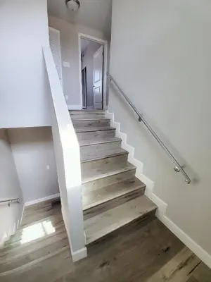 a staircase in a house with wooden floors at Modern Hostel address changed in Los Angeles