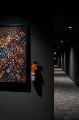 a fire hydrant hanging on a wall next to a painting at SIRTAJ – Beverly Hills in Los Angeles