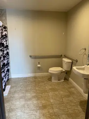 a bathroom with a toilet and a sink at El Rey Inn - LAX in Gardena
