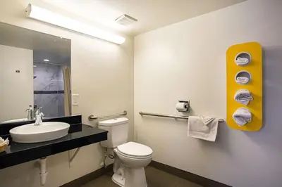 a bathroom with a toilet and a sink and a mirror at Motel 6-Ventura, CA - Downtown in Ventura