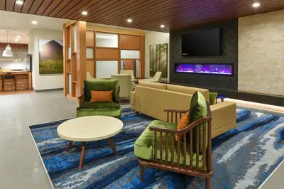 a lobby with a living room with a couch and a tv at Fairfield Inn & Suites by Marriott Moorpark Ventura County in Moorpark