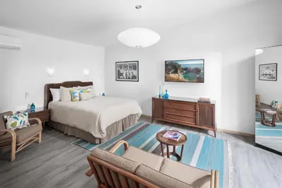 a bedroom with a bed and a couch and a table at Mid-Mod Retro Private Studio & Pool in Long Beach