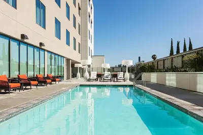 a swimming pool in front of a building at Courtyard by Marriott Los Angeles Monterey Park in Monterey Park