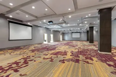 a large room with a large wooden floor and a screen at Courtyard by Marriott Los Angeles Monterey Park in Monterey Park