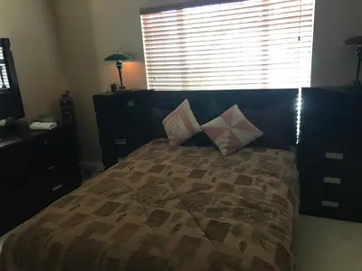 a bedroom with a bed with pillows and a window at paradise luxury experience in Woodland Hills