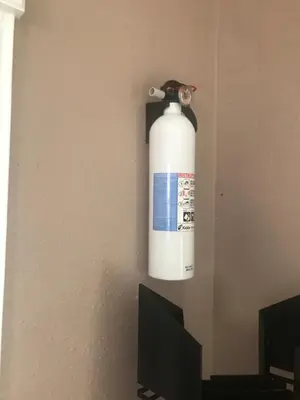 a fire extinguisher hanging on the corner of a wall at paradise luxury experience in Woodland Hills