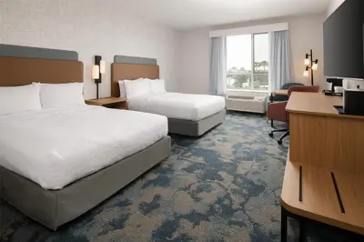 a hotel room with two beds and a desk at Hampton Inn by Hilton North Hollywood in North Hollywood