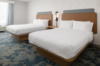 two beds in a hotel room with white sheets at Hampton Inn by Hilton North Hollywood in North Hollywood