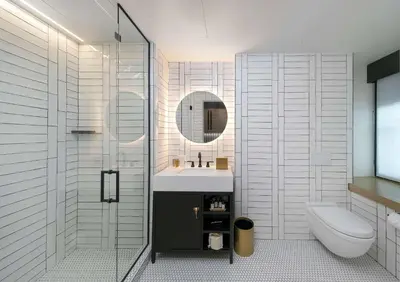 a bathroom with a sink and a toilet and a mirror at The Wayfarer Downtown LA, Tapestry Collection by Hilton in Los Angeles