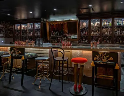 a bar with four stools in front of a counter at The Wayfarer Downtown LA, Tapestry Collection by Hilton in Los Angeles