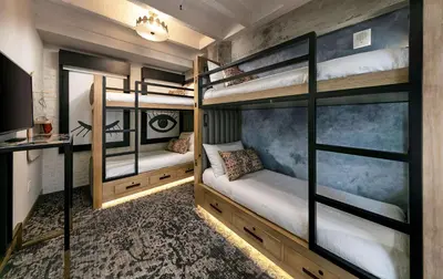 a room with bunk beds with a tv and a desk at The Wayfarer Downtown LA, Tapestry Collection by Hilton in Los Angeles