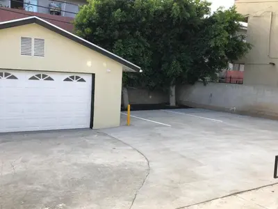a large parking lot with a white garage at 8th and Ardmore in Los Angeles