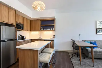 a kitchen with a refrigerator and a table at Element Ontario Rancho Cucamonga in Ontario