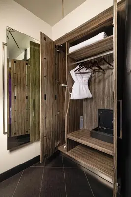 a room with a closet with wooden walls and a mirror at The Moment Hotel in Los Angeles
