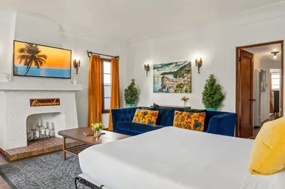 a living room with a blue couch and a fireplace at Visit the Beach from a Historic Downtown Apartment - NRP21-00092 in Long Beach