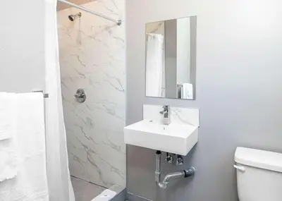 a bathroom with a white sink and a mirror at Motel 6 San Pedro, CA Port of Los Angeles in San Pedro