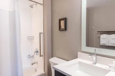 a white bathroom with a sink and a mirror at TownePlace Suites by Marriott Thousand Oaks Agoura Hills in Agoura Hills