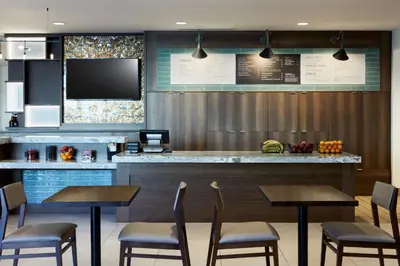 a restaurant with a bar with chairs and a tv at TownePlace Suites by Marriott Thousand Oaks Agoura Hills in Agoura Hills