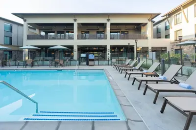 a swimming pool with lounge chairs and a building at TownePlace Suites by Marriott Thousand Oaks Agoura Hills in Agoura Hills