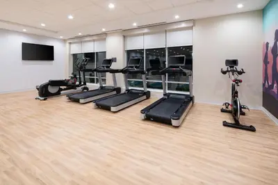 a gym with treadmills and exercise bikes in a room at Hyatt Place Bakersfield in Bakersfield