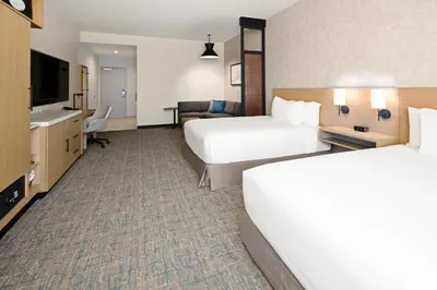 a hotel room with two beds and a television at Hyatt Place Bakersfield in Bakersfield