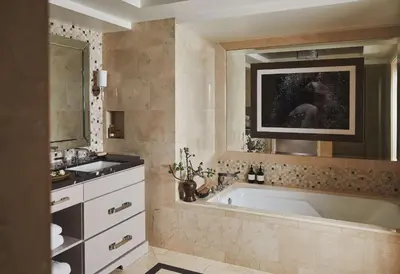 a bathroom with a large tub and a sink at L'Ermitage Beverly Hills in Los Angeles