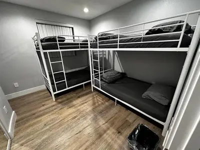 two bunk beds in a room with wooden floors at Green HomeStay address changed in Los Angeles