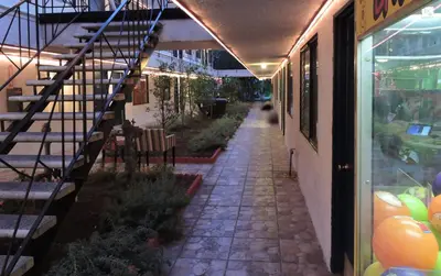 a walkway next to a building with a stair case at Tradewinds Airport Hotel in Inglewood