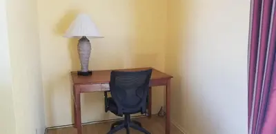 a desk with a chair and a lamp on it at Lotus by Hotel Inn in Ontario
