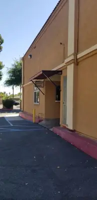 an empty parking lot in front of a building at Lotus by Hotel Inn in Ontario