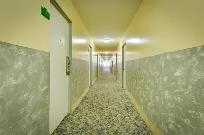 a corridor of a hallway with a long corridor at Vagabond Inn Long Beach in Long Beach