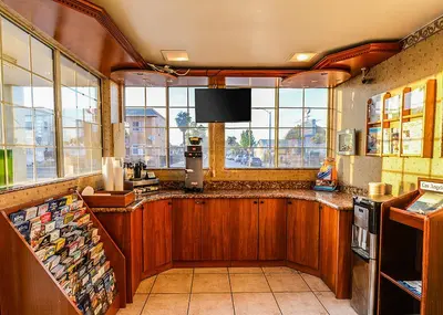 a kitchen with a counter with a large window at Aqua Venture Inn in Long Beach