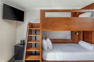 a bedroom with a bunk bed with a television at FOUND Hotels, Santa Monica, Series by Marriott in Los Angeles