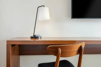 a desk with a lamp and a chair at FOUND Hotels, Santa Monica, Series by Marriott in Los Angeles