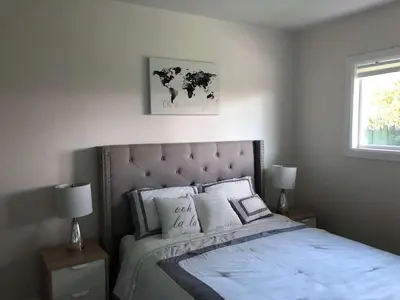 a bedroom with a large bed with white sheets and pillows at Fully remodeled Beautiful house in West Covina in West Covina