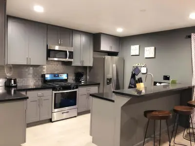 a kitchen with white cabinets and stainless steel appliances at Fully remodeled Beautiful house in West Covina in West Covina