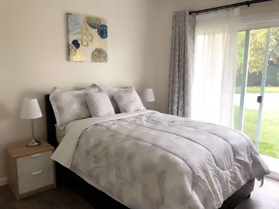 a bedroom with a large bed and a window at Fully remodeled Beautiful house in West Covina in West Covina