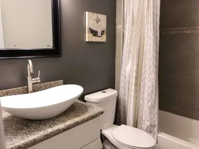 a bathroom with a white sink and a toilet at Fully remodeled Beautiful house in West Covina in West Covina