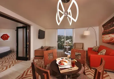 a living room with a red couch and a table at Hotel Angeleno in Los Angeles