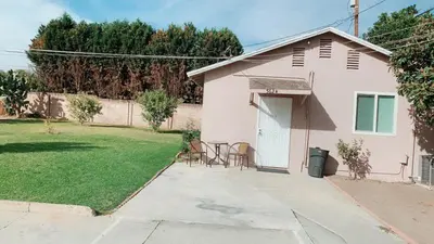 a small pink house with chairs and a yard at Pasadena single house 3b1b \u4e09\u623f\u4e00\u5385\u4e00\u53a8\u4e00\u6d74 in Pasadena