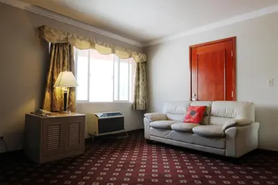 a living room with a couch and a window at Metro Plaza Hotel in Los Angeles