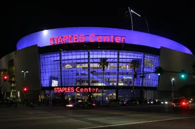 a starbucks center lit up in blue at night at Metro Plaza Hotel in Los Angeles