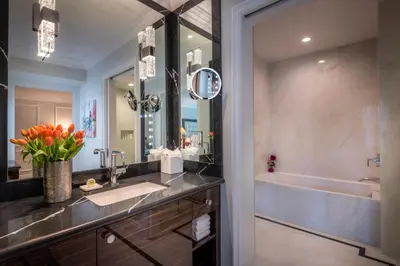 a bathroom with a sink and a tub at Beverly Hills Plaza Hotel & Spa in Los Angeles