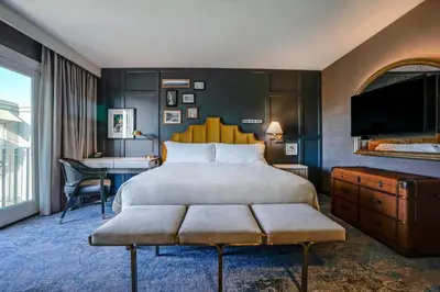 a bedroom with a large bed and a desk at Hotel Amarano Burbank-Hollywood in Burbank